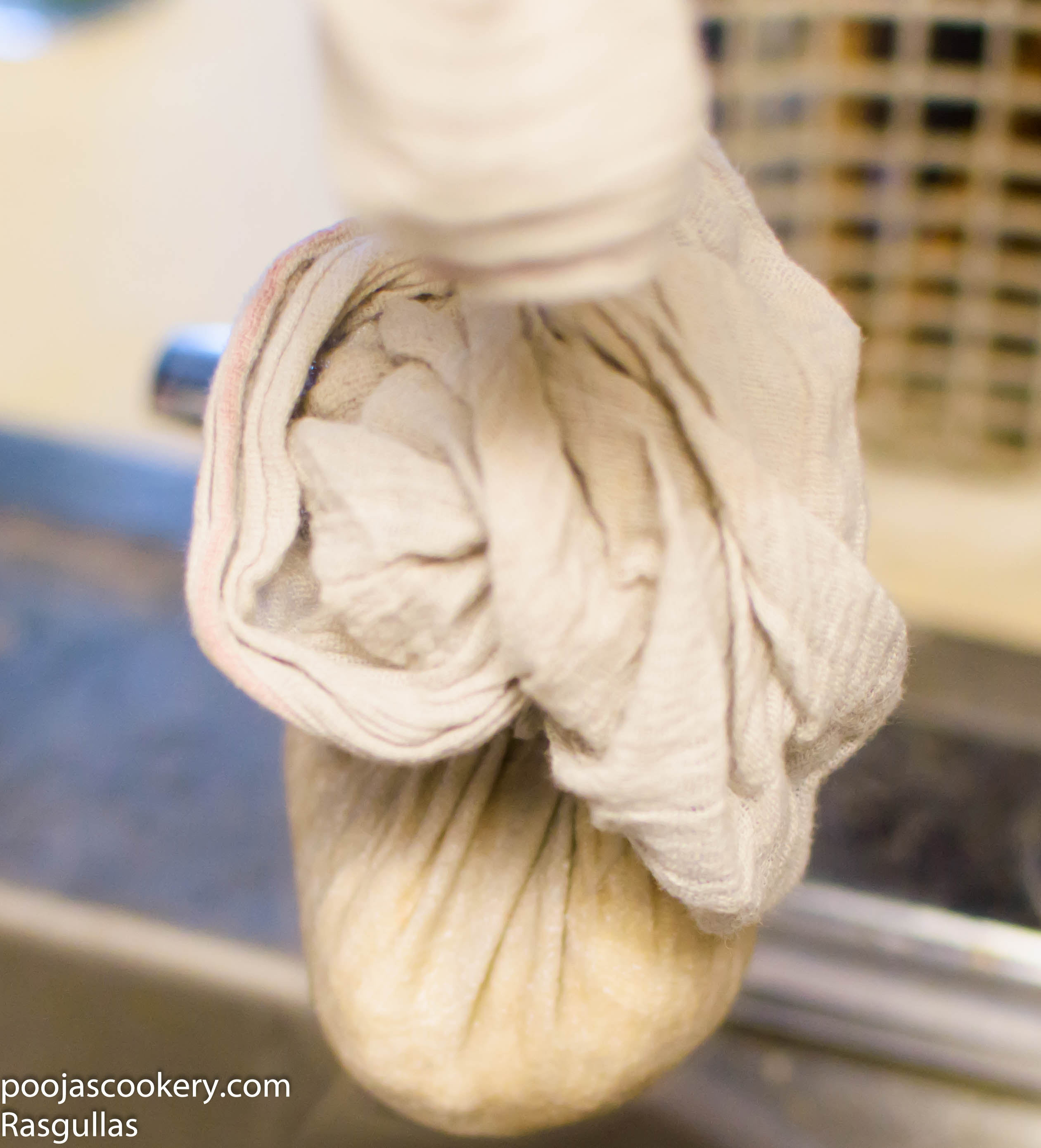 Muslin cloth tied high up for whey to drain away