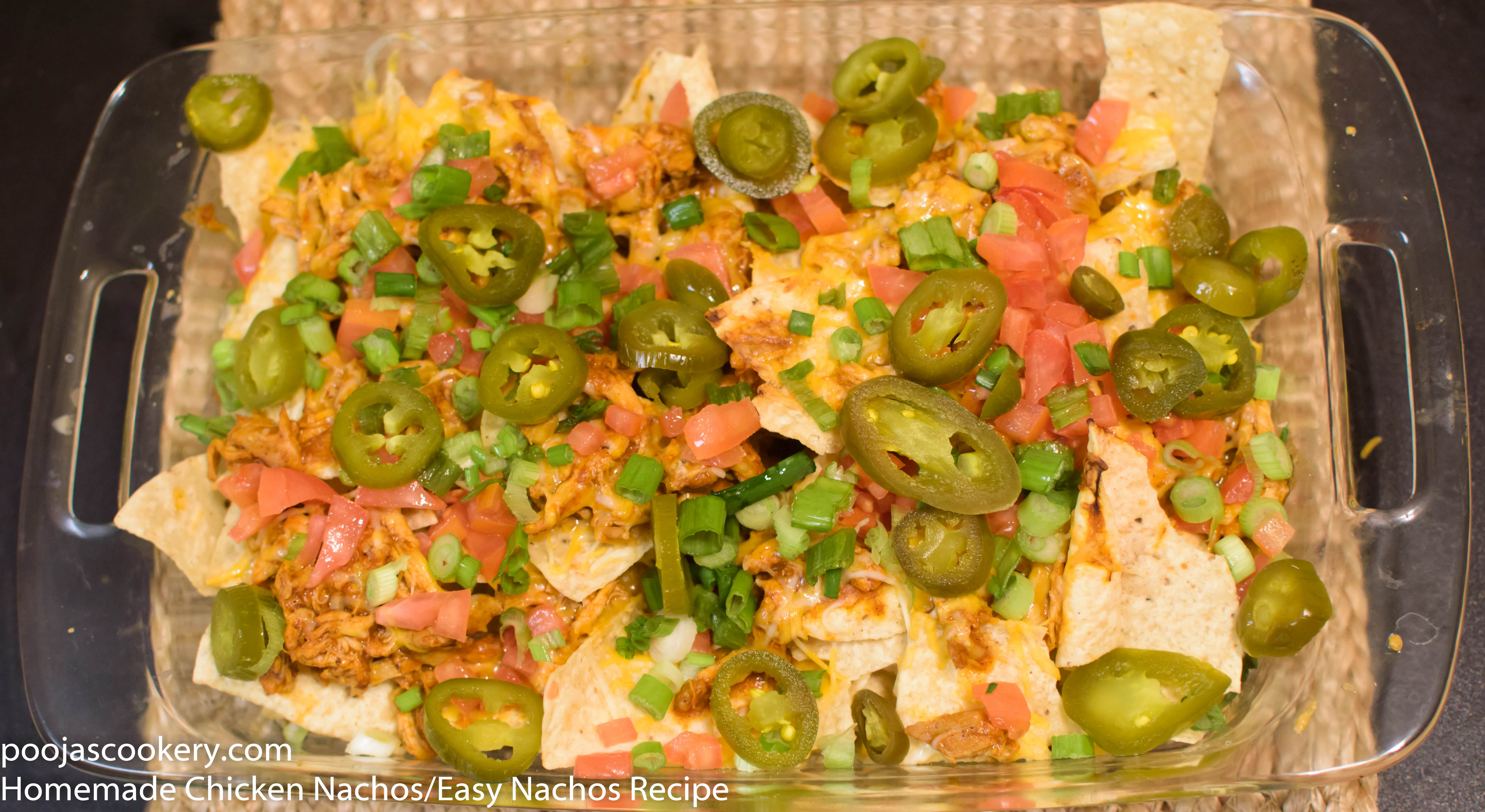 Baked Nachos are garnished with tomatoes and Jalepanos