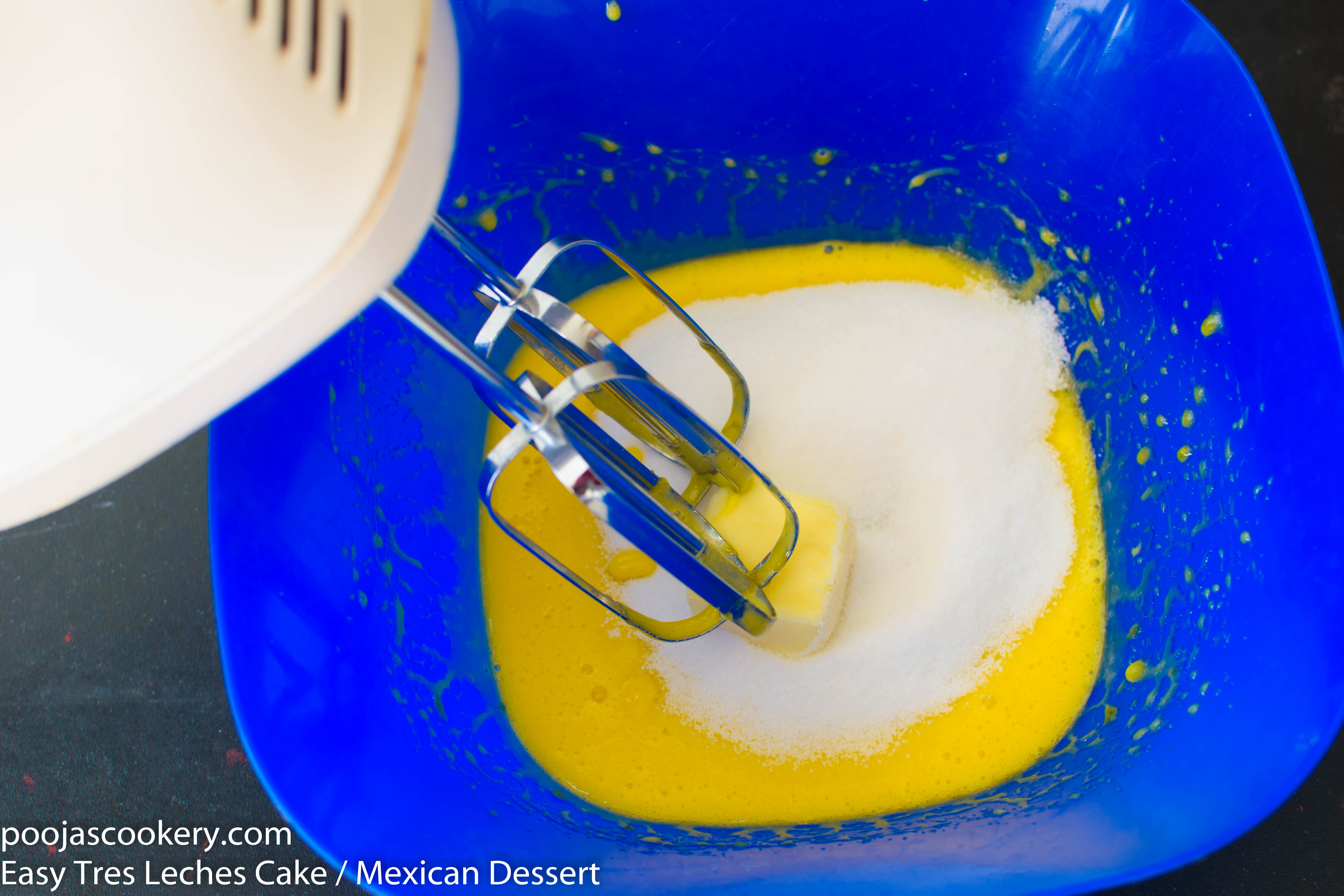 Sugar and butter into beaten egg yolks